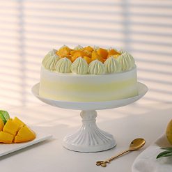Top view mango birthday cream cake with mango cubes