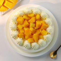 Mango birthday cream cake with birthday topper