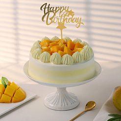 Mango birthday cream cake with mango pieces