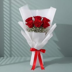 Pineapple cake paired with six fresh red roses