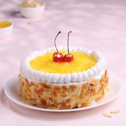 Side view of fresh pineapple whipped cream cake