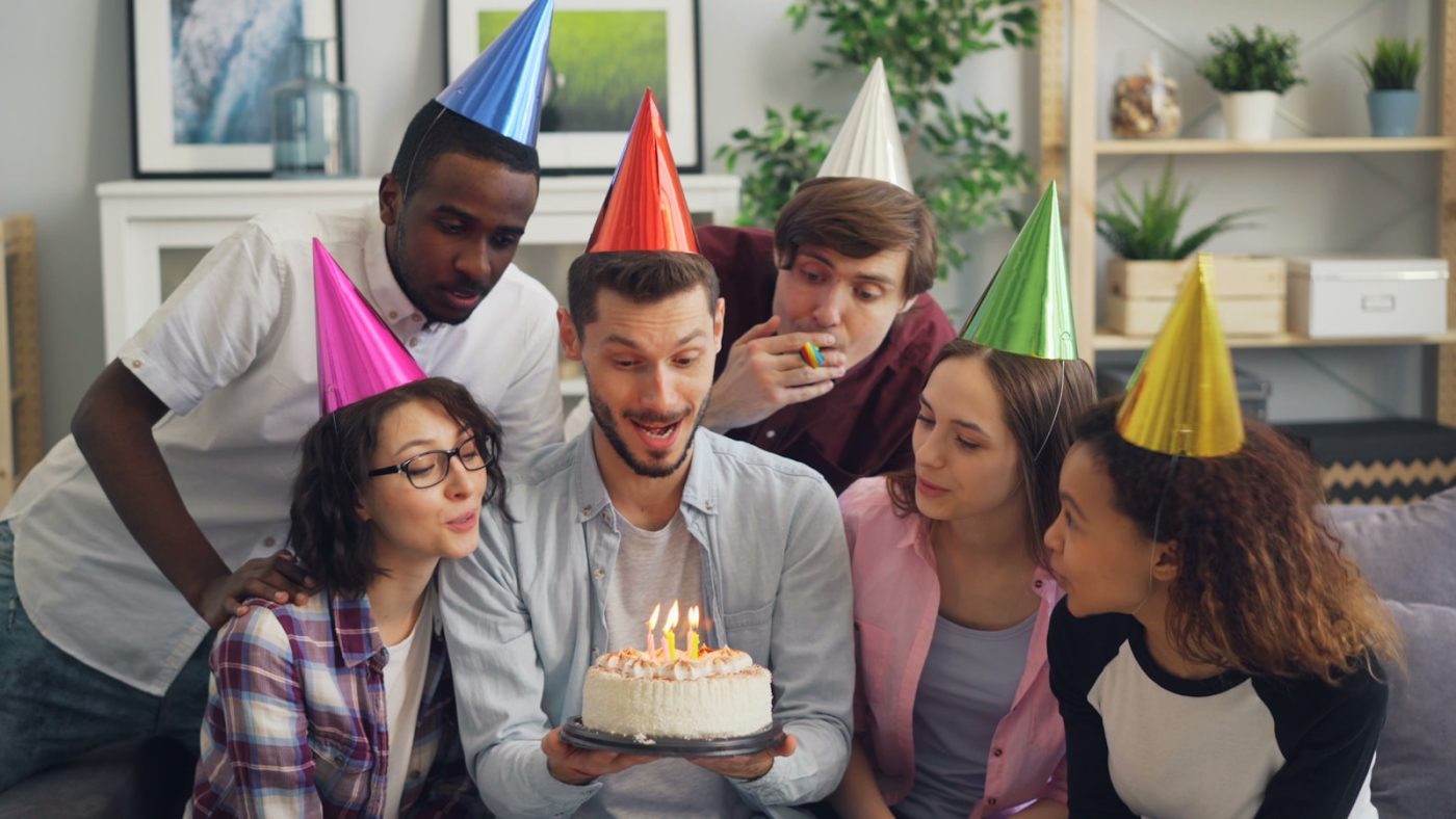 Family members gathered around a cake for a Brother’s Day celebration