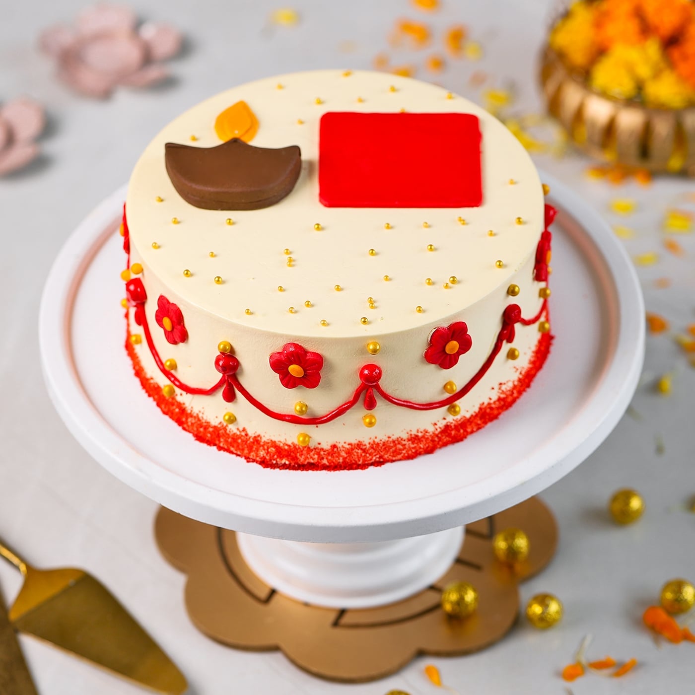 Diwali diya cake with red floral decoration