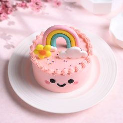 Top view of colourful rainbow smiles bento cake