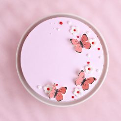 Red velvet cake top view with pink butterflies